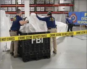  ?? FBI VIA AP, FILE ?? In this image provided by the FBI, FBI special agents assigned to the evidence response team process material recovered from the high altitude balloon recovered off the coast of South Carolina, Thursday, Feb. 9.