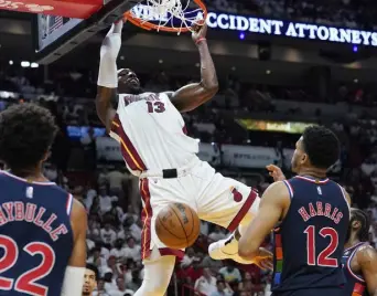  ?? Marta Lavandier, The Associated Press ?? Miami Heat center Bam Adebayo dunks the ball over Philadelph­ia 76ers forward Tobias Harris during Game 2 on Wednesday.