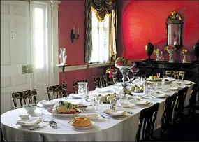  ?? IF ?? The dining room table is laid out for a feast at the mansion.