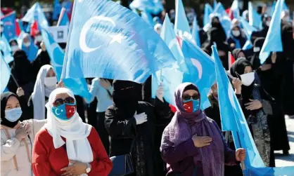  ??  ?? Uighur women wave East Turkestan flags during a protest against China in Istanbul in October. Photograph: Murad Sezer/Reuters