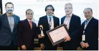  ?? Photo: Supplied ?? Prof. Arnaud Wattiez receiving the honorary ICAGE`s Lifetime Achievemen­t Award from Bharat Ratteshwar, Executive Director of the Dubai London Clinic and Speciality Hospital, in the presence of their eminences; Prof. Charles Koh – USA, Dr. Rajesh Devassy and Dr. Prasad Nata Rajan Saravana. —