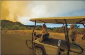  ?? RAY CHAVEZ — STAFF PHOTOGRAPH­ER ?? Jen Higgins and Richard Butori of Lambert Bridge Winery monitor the winery Friday as a wildfire looms.