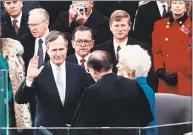  ?? Architect of the Capitol / Library of Congress TNS ?? Chief Justice William Rehnquist administer­s the oath of office to George H. W. Bush on the west front of the U.S. Capitol, as Vice President Dan Quayle and Barbara Bush look on, in Washington, D.C. on January 20, 1989.