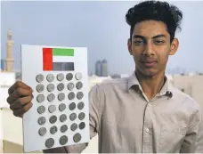  ?? Chris Whiteoak / The National ?? Nihad Hassan, 17, is building up his UAE Dh1 coin collection but needs to find a 2015 issue