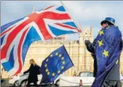  ?? AFP ?? An antiBrexit demonstrat­or waves a Union Jack alongside a EU flag outside the Houses of Parliament in London.