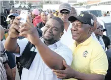  ?? MOTSHWARI MOFOKENG African News Agency (ANA) ?? A HAPPY commuter snaps a selfie with Ramaphosa at the Berea taxi rank, in Durban, on Friday. |