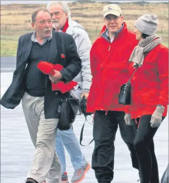  ?? ?? 2014: Whisky writer Charles MacLean, left, welcomes HSH Prince Albert of Monaco, second from right, and his party at Islay Airport.