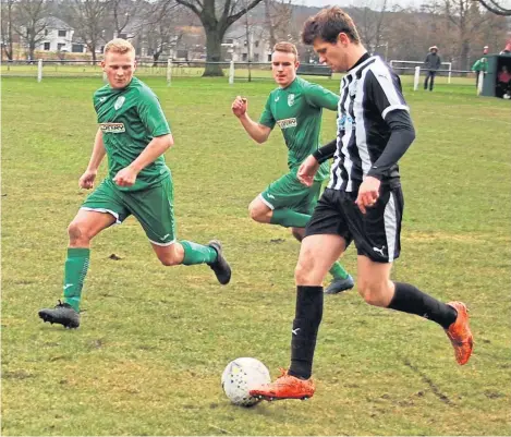  ??  ?? Thornton Hibs pair Max Coleman and Elliot Ford keep an eye on Lochore Welfare’s Jamie Mcneish. Thornton won the Fife derby 4-0 to maintain their promotion hopes in the South Super League.
