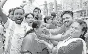  ?? REUTERS ?? BJP supporters apply colour as they celebrate the party’s win in Agartala on Saturday.