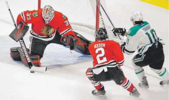  ?? | AP ?? Goalie Scott Darling and defenseman Duncan Keith defend against former Hawk and current Stars right wing Patrick Sharp during the third period in the preseason finale.