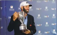  ?? Frank Franklin II / Associated Press ?? Dustin Johnson poses with the trophy after winning the Travelers Championsh­ip Sunday in Cromwell.