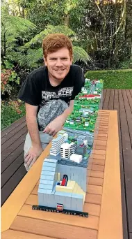  ??  ?? Chris Lepper, 31, with his 1:600 scale moving model of the Wellington cable car, made out of Lego, for the Great Wellington­NZ Brick Challenge.