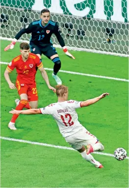  ?? —
AP ?? Kasper Dolberg of Denmark shoots to score his second goal against Wales during the Euro Round of 16 match at Johan Cruyff Arena in Amsterdam on Saturday.