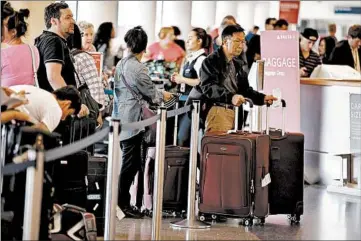  ?? MARK BOSTER/TRIBUNE NEWS SERVICE ?? Long lines at the airport are a drag, but a little bit of money can help make them shorter or disappear completely.