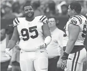  ??  ?? Colts defensive end Johnathan Hankins (95) talks to nose tackle Al Woods (99) during a game against the Texans. SHANNA LOCKWOOD/USA TODAY