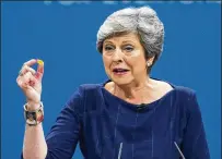  ?? DAVID HARTLEY / TNS ?? British Prime Minister Theresa May speaks at the Conservati­ve Party Conference Oct. 4 in Manchester, England. Debates and voting on the European Union (Withdrawal) Bill start Tuesday. May faces pressure from lawmakers on both sides of the Brexit issue.