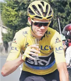  ??  ?? Yellow jersey leader Team Sky rider Chris Froome of Britain holds a glass of champagne after the start of the 113-km (70,4 miles) Tour de France Stage 21 from Chantilly to Paris in France in this July 24 file photo. — Reuters photo