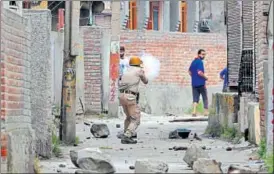  ?? AP ?? A policeman fires a teargas shell to disperse protesters in Srinagar on Wednesday.