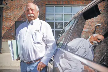  ?? GABRIELA CAMPOS/THE NEW MEXICAN ?? Stanford Weinstein, a 74-year-old retired trial attorney, stands next to his vehicle where in early 2018 he received a $250 ticket for a parking violation. After an 18-month legal fight, the ticket has been refunded and his court costs have been paid.