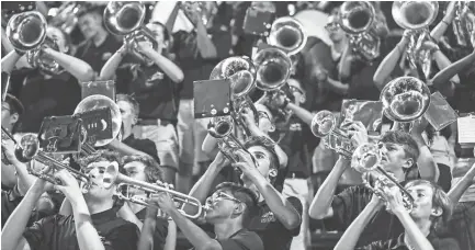  ??  ?? The Colliervil­le marching band performs during a Friday night football game between Colliervil­le and Bartlett.