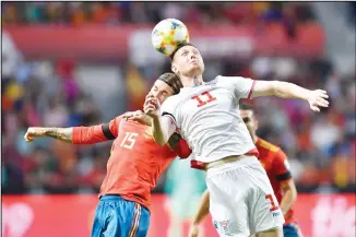  ??  ?? Spain’s Sergio Ramos (left), jumps for the ball with Faroe Islands’ Kaemint Olsen during the Euro 2020 Group F
qualifying soccer match between Spain and Faroe Islands at the Molinon stadium in Gijon, Spain on Sept 8. (AP)