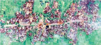  ??  ?? Top: Rohingya Muslims from Burma near a refugee camp in Bangladesh. New satellite imagery shows hundreds of burnt buildings in Burma’s Rakhine State, above.