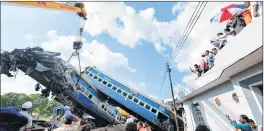  ?? PTI ?? On Sunday, heavy cranes removed the mangled coaches from the tracks.