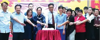  ??  ?? Lau (front row, fourth left) with others during the cutting of Teachers’ Day cake ceremony.