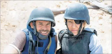  ?? AP PHOTO ?? Photograph­er Paul Conroy, left, is shown with war correspond­ent Marie Colvin in Misrata, Libya. A new documentar­y recounts in searing detail the final days of Colvin, who was killed in shelling from Syrian President Bashar Assad’s forces in 2012 in the city of Homs, where she was documentin­g civilian suffering.
