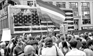  ??  ?? File photo shows rainbow flag flies as people protest Trump’s announceme­nt that he plans to reinstate a ban on transgende­r individual­s from serving in any capacity in the US military, in Times Square, in New York City, New York, US. — Reuters photo