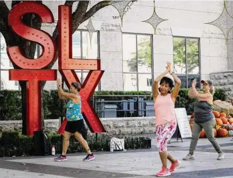  ?? Photos by Annie Mulligan/Contributo­r ?? A large “SLTX” sculpture serves as a backdrop for a free weekly Zumba class led by instructor Cida Moore on Nov. 11 at Sugar Land Town Square.