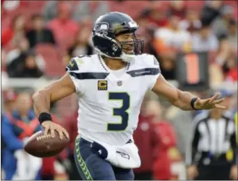  ?? DON FERIA — THE ASSOCIATED PRESS ?? Seahawks quarterbac­k Russell Wilson, here looking for an open receiver against the San Francisco 49ers last Sunday, will be one of the Eagles defense’s stiffest quarterbac­k tests of the season when the teams meet in Seattle this Sunday night.