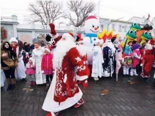  ?? Reuters ?? FANCY PARTY: People, dressed as Father Frost, Russian equivalent of Santa Claus, and other fancy costumes, attend a New Year festival in Yevpatoria, Crimea, on Saturday.