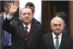  ??  ?? File photo of Erdogan (left) flanked by Yildirim, greeting the crowd during his party’s group meeting at the Grand National Assembly of Turkey in Ankara. — AFP photo