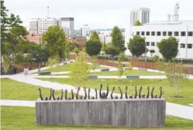  ?? JOHNATHON KELSO/THE NEW YORK TIMES ?? Artist Hank Willis Thomas created the sculpture “Raise Up” on the grounds of the National Memorial for Peace and Justice.