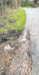  ??  ?? Rainwater run-off at Burke’s Cross, following more recent heavy rainfall. The road surface has deteriorat­ed over time and is a cause of concern to locals.