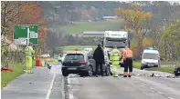  ??  ?? Police investigat­ors work at the crash site on the A96