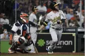  ?? ERIC CHRISTIAN SMITH — THE ASSOCIATED PRESS ?? The Oakland Athletics’ Jed Lowrie, right, watches his two-run single during the seventh inning Saturday against the Houston Astros in Houston.