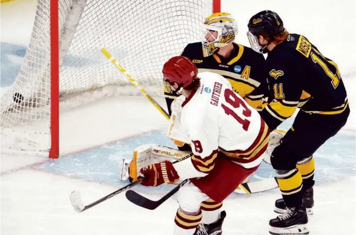  ?? BARRY CHIN/GLOBE STAFF ?? Cutter Gauthier draws first blood with his first-period goal in Boston College’s 6-1 victory over Michigan Tech in the NCAA hockey regional in Providence.