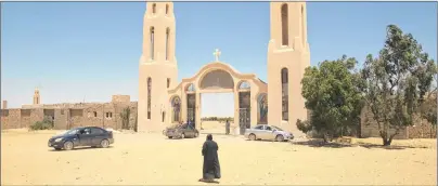  ?? AP FILE PHOTO ?? A priest walks in front of St. Samuel the Confessor Monastery in Maghagha, Egypt, in this May 27, 2017 photo.