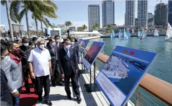  ?? — AFP photo ?? Sri Lanka President Gotabaya Rajapaksa (second right) arrives with Wang Yi (front right) at a sailing event on the occasion of the 65th anniversar­y of diplomatic relations between the Sri Lanka and China at Colombo Port city project, in Colombo.