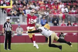  ?? GODOFREDO A. VÁSQUEZ — THE ASSOCIATED PRESS ?? San Francisco 49ers quarterbac­k Jimmy Garoppolo (10) passes against New Orleans Saints defensive end Malcolm Roach in Santa Clara last Sunday.