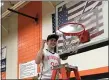  ?? NATE BARNES — THE NEWS-HERALD ?? Newbury’s Jacob Orms cuts down part of the net following the Black Knights’ victory against Maplewood on Feb. 25.