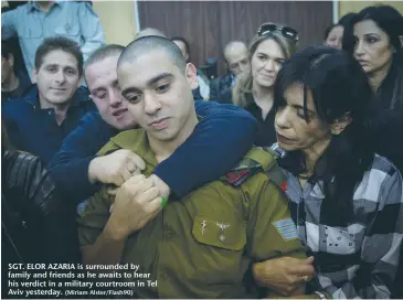  ?? (Miriam Alster/Flash90) ?? SGT. ELOR AZARIA is surrounded by family and friends as he awaits to hear his verdict in a military courtroom in Tel Aviv yesterday.