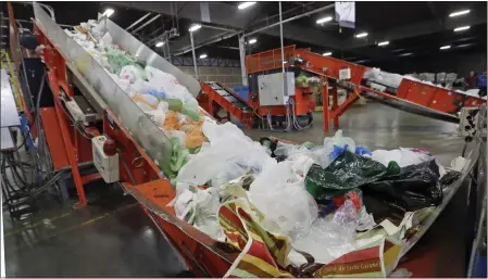  ?? REED SAXON — THE ASSOCIATED PRESS ?? Conveyors carry mixed plastic into a device that will shred them at a plastics recycling plant in Vernon in 2014.