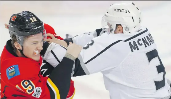  ?? AL CHAREST ?? Flames rookie Matthew Tkachuk mixes it up with Brayden McNabb of the Los Angeles Kings Wednesday night at the Saddledome in a 4-1 Calgary loss.