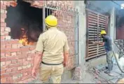  ?? HT PHOTO ?? Firemen outside the house that was burnt in Karnal town on Thursday.