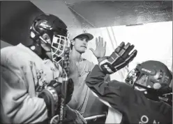  ?? Herald photo by Tijana Martin ?? Brandon Davidson greets Ver-Set Skills Camp participan­ts before a session on the ice in Taber on Thursday.