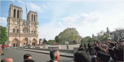  ?? POOL PHOTO BY MICHEL EULER ?? France pays tribute Thursday to the Paris firefighte­rs who saved Notre Dame Cathedral from collapse and rushed to protect precious religious artifacts when the fire broke out Monday.