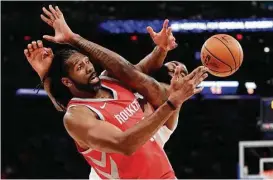  ?? Frank Franklin II / Associated Press ?? The Rockets’ Nene, left, tangles with the Knicks’ Kyle O’Quinn on Wednesday.